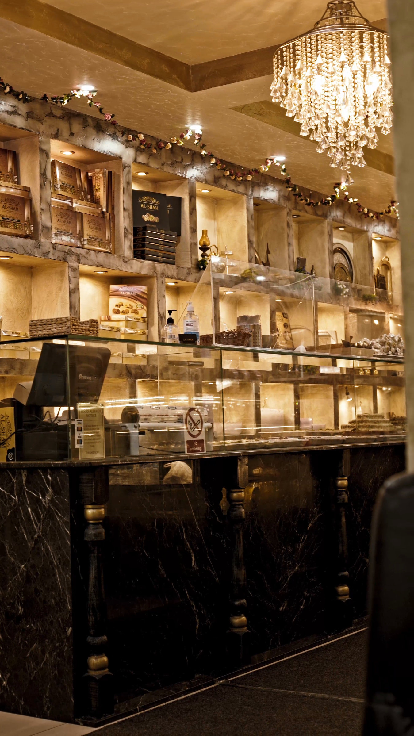 A warm restaurant interior with pendant lights and shelves from a genuine film.