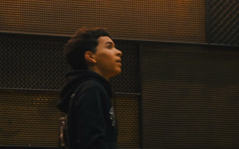 A genuine brand-film frame with a model and basketball.